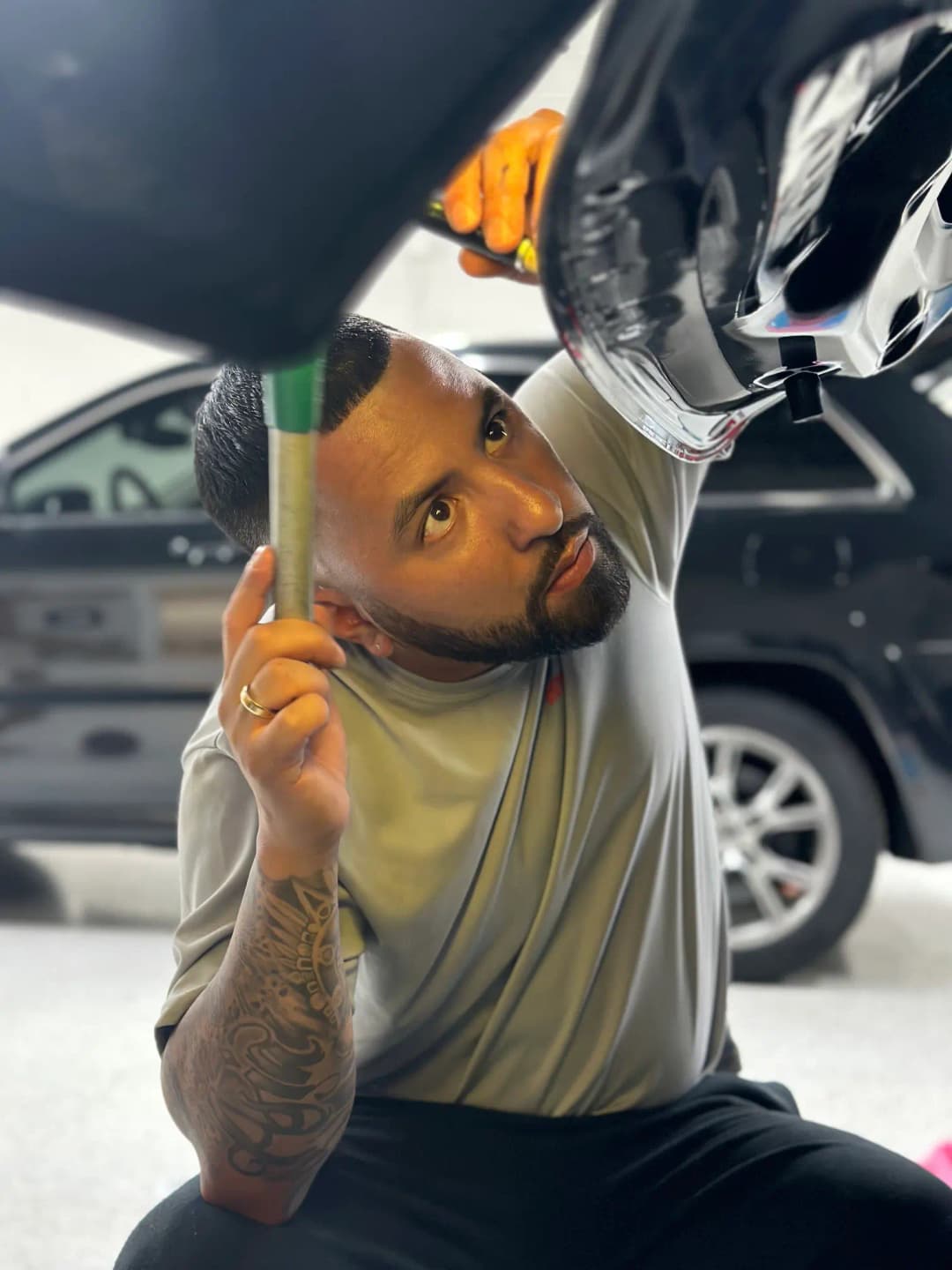 Owner of DentBusters fixing a dent